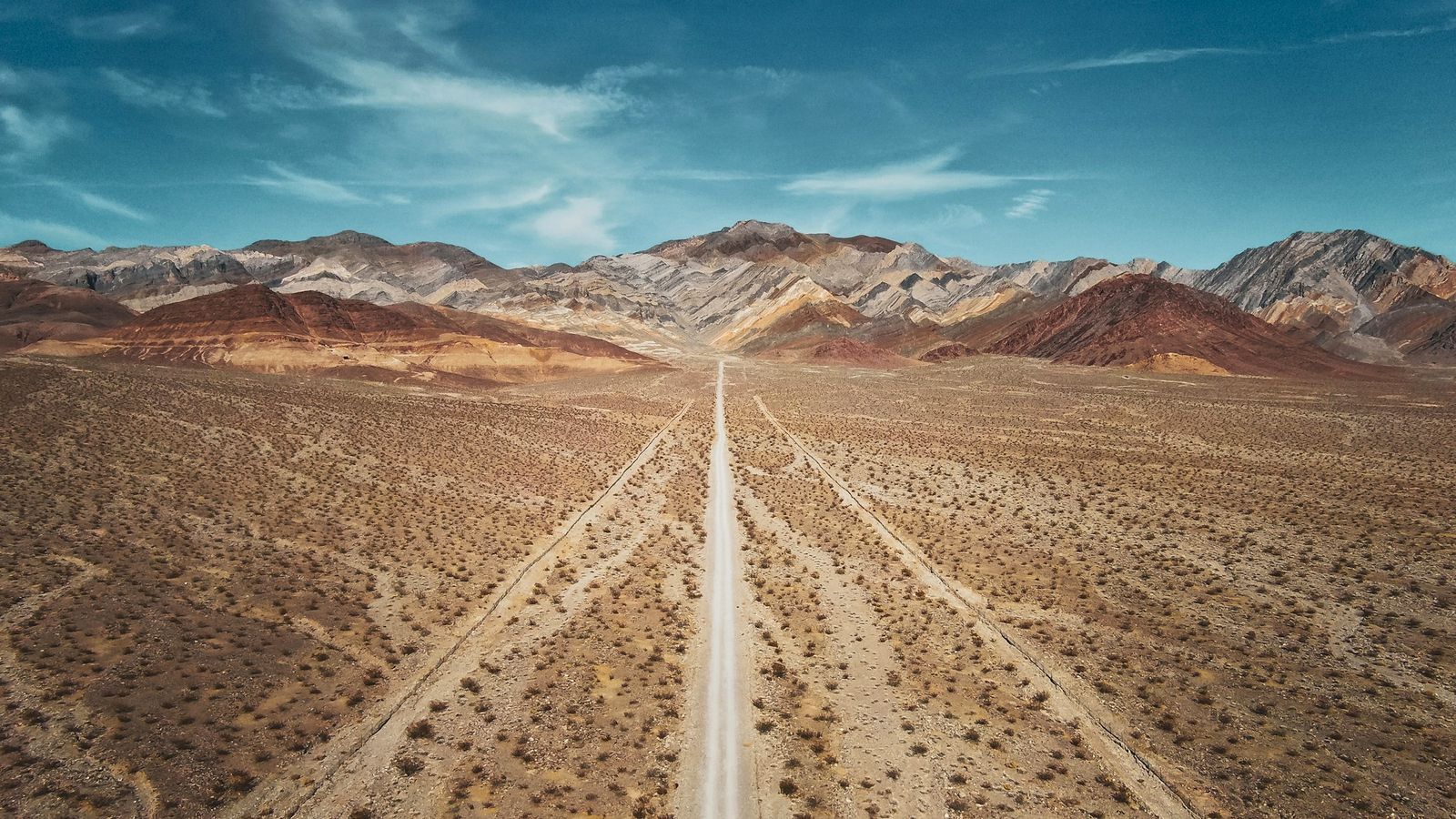 An empty desert highway stretching toward the horizon